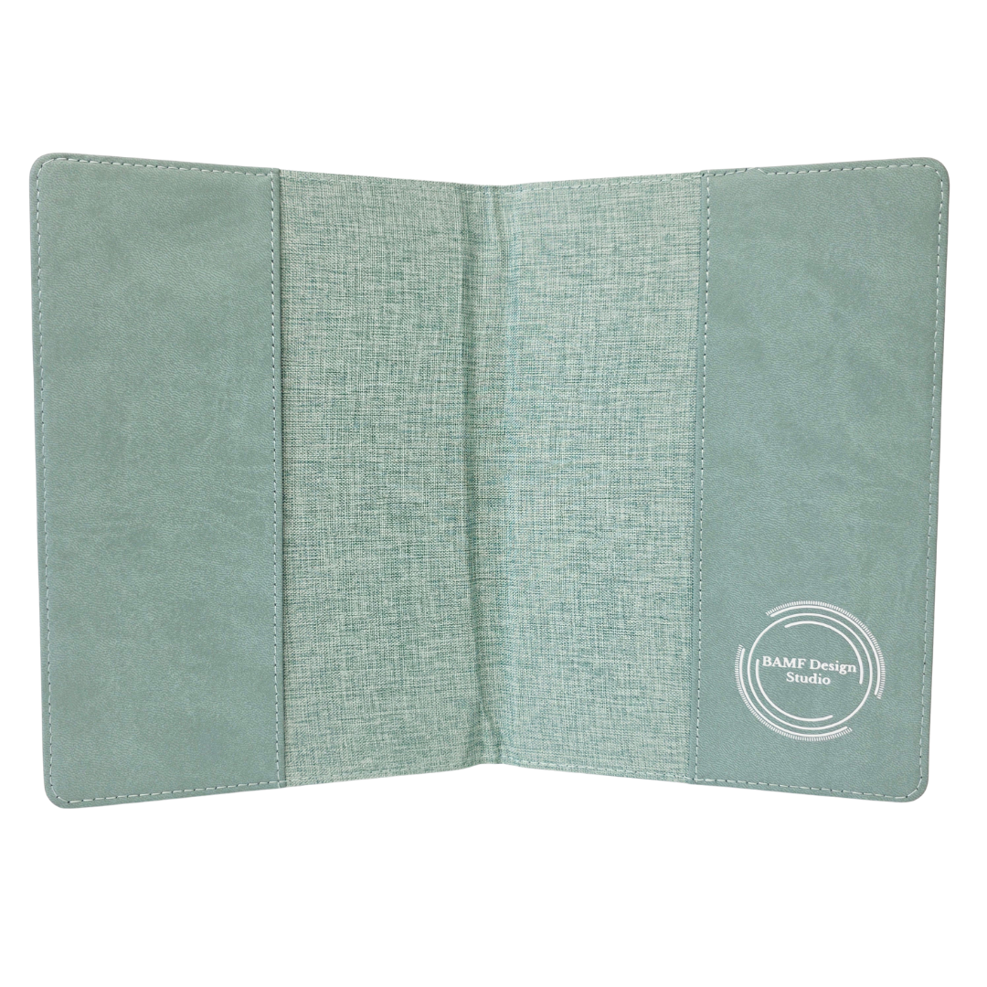 Inside of a green fabric journal cover with a visible brand logo on a white background