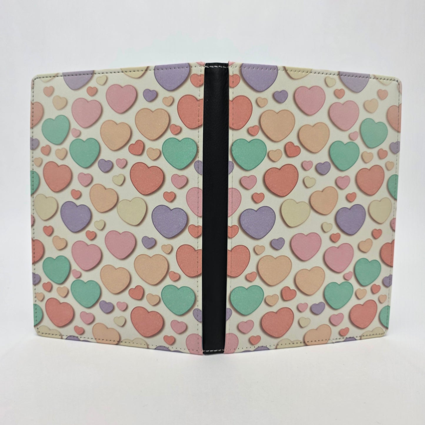 Journal cover with a colorful candy heart pattern in pastel colors on a light yellow background.