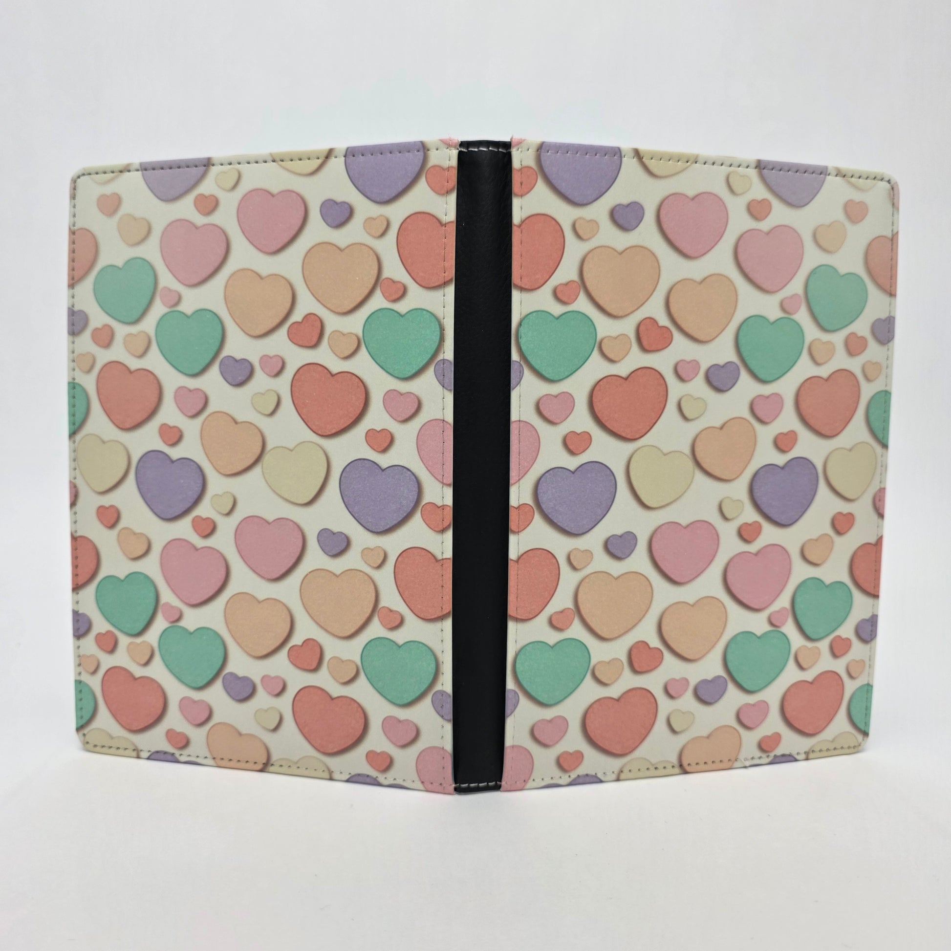 Journal cover with a colorful candy heart pattern in pastel colors on a light yellow background.