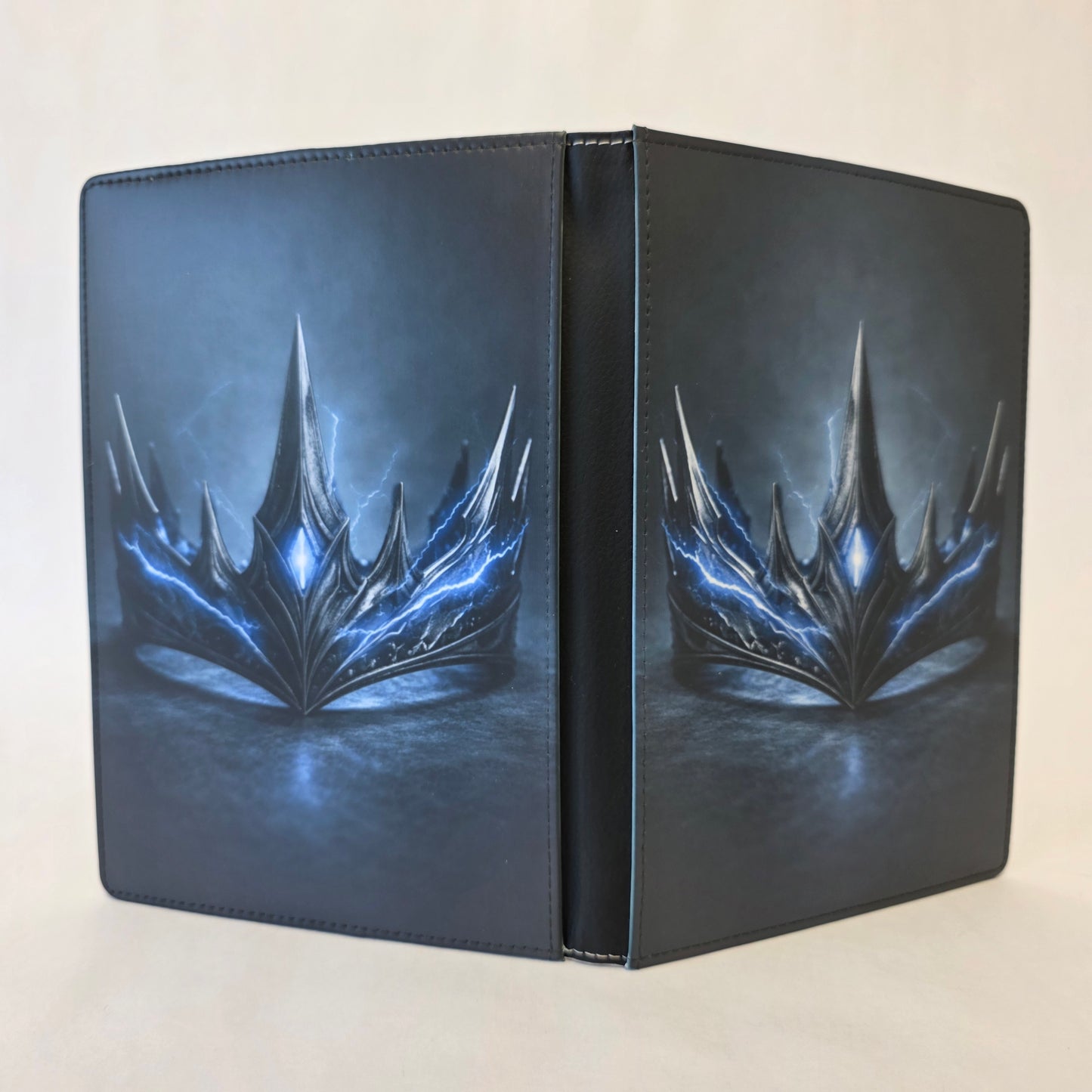 Journal cover featuring a metal crown with blue lightening intertwined. Image on front and back cover.