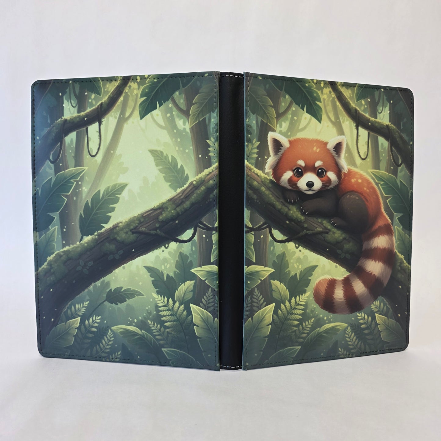 Notebook cover with a red panda with a forest background on front and back covers.