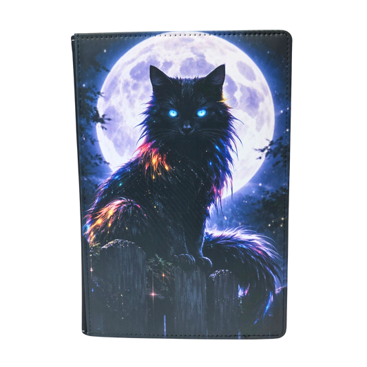 A journal cover with a black cat sitting on a fence in front of a full moon.