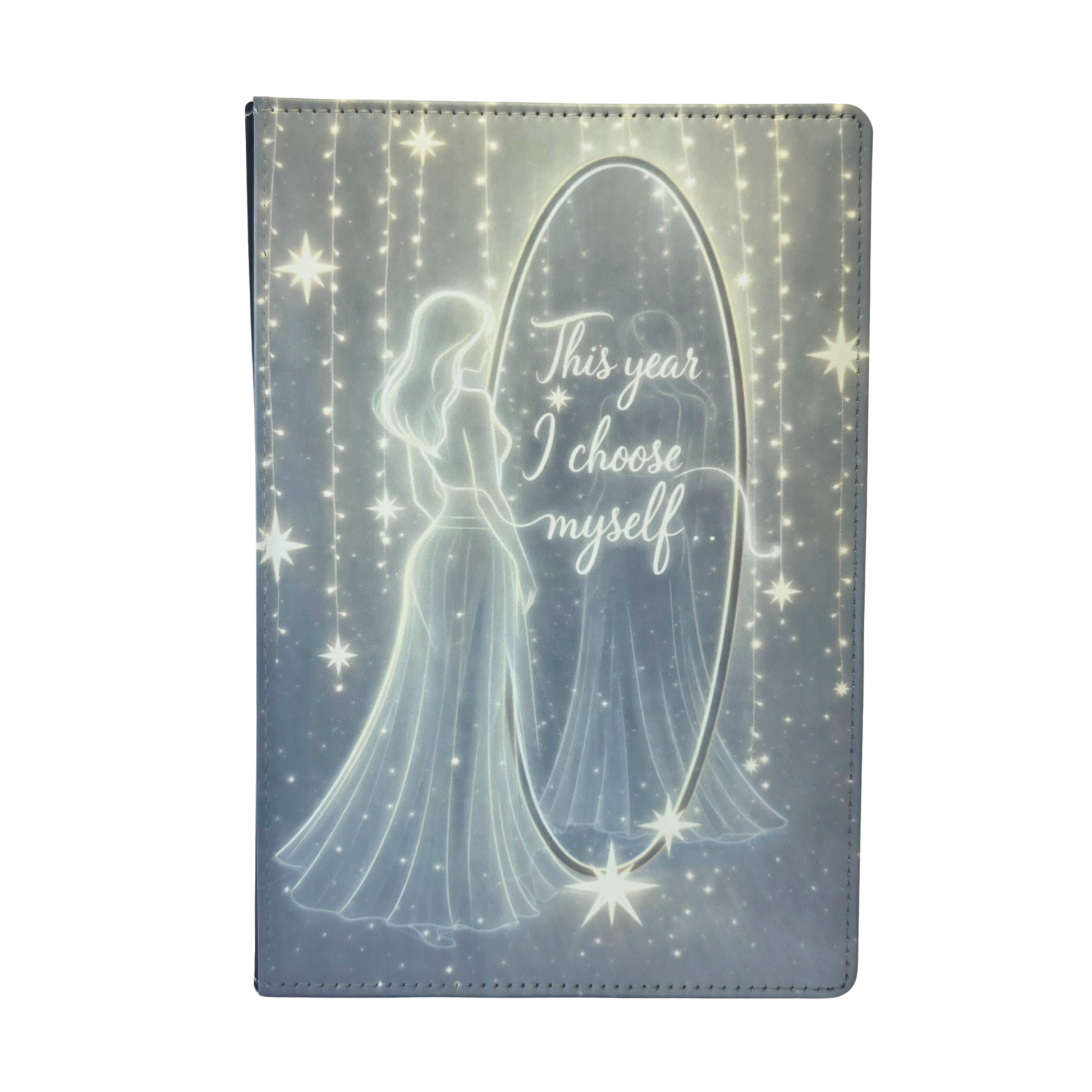 Journal cover with a silhouette of a woman looking into a mirror and 'This year I choose myself' text on the mirror. Yellow and gray tones, with a slight glow.